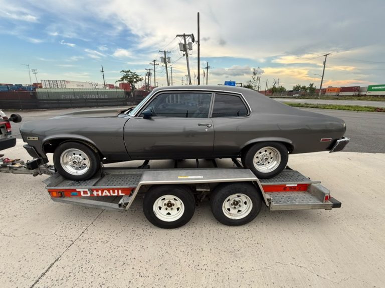 1973 Chevrolet Nova coupe in dark grey on a trailer in New Jersey